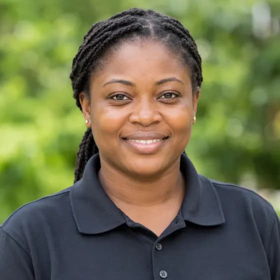 Sample portrait: a smiling woman in a dark polo shirt
