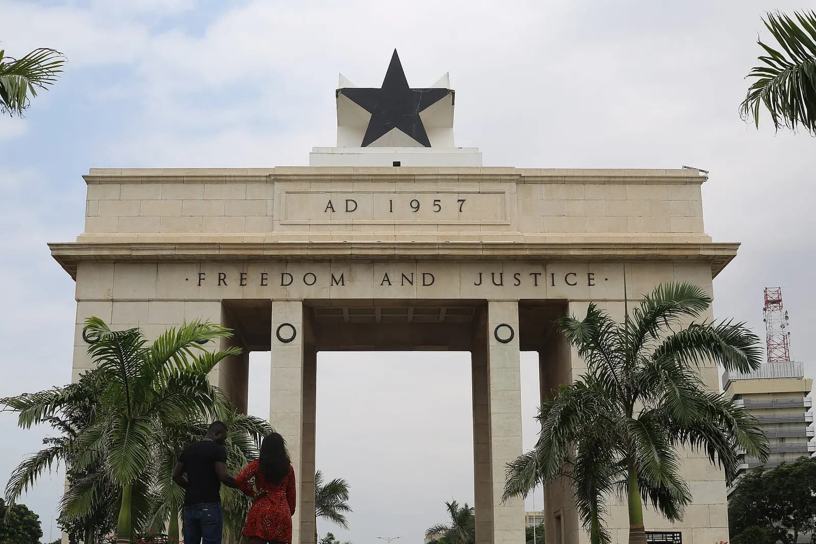 The Black Star Gate in Accra, inscribed AD 1957 and Freedom and Justice, framed by palm trees